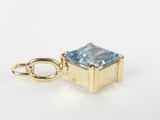 an image of a blue topaz stone pendant on a gold plated chain