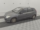 a picture of a small grey car parked in a garage
