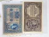 two old paper money sitting on a table