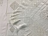 a close up of a white table cloth with crochets on it