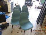 four chairs sitting in a room with a lot of clutter on the floor