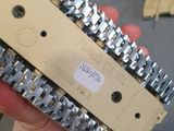 a person holding a metal chain that is attached to a piece of equipment