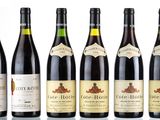 six bottles of wine are lined up in a row