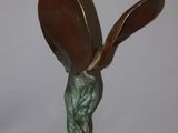 statue of a woman holding a spoon and a spoon in her hand
