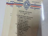 two french military documents are on a white surface