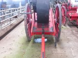 a red fire engine sitting in the middle of a barn