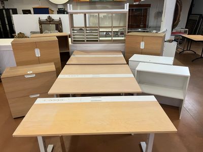 many desks and cabinets in this room together