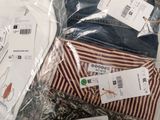 a lot of clothes that are wrapped in plastic bags