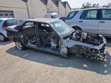 a car that is sitting in the parking lot with the door open