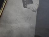 an old photo of a man in a military uniform holding his hand