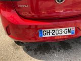 a close up of a red car with a license plate on it