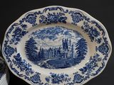 a blue and white plate with a picture of a castle on it