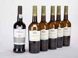 six bouteilles de vin posées les unes à côté des autres sur une surface blanche