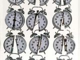 many clocks that are arranged in a row on the table