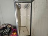 an image of a refrigerator in a room with a lot of boxes of fruit