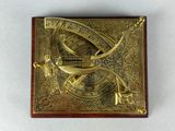 an old brass sundial on a wooden surface with a white background