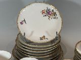 a lot of cups and saucers sitting on a table
