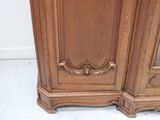 a wooden cabinet with a mirror on top of it