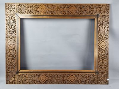 a gold frame with a floral design on it