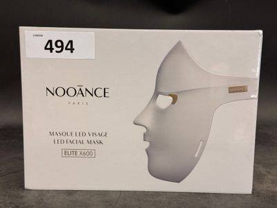 a box with a white mask on it on a table