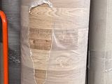 many rolls of paper on a shelf in a warehouse