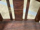 a wooden chair that is sitting in a room