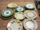 many plates that are sitting on a wooden table