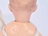 a small doll that is sitting next to a mirror