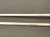 two old swords are sitting on a table next to each other