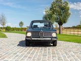 a car that is parked on a cobblestone road
