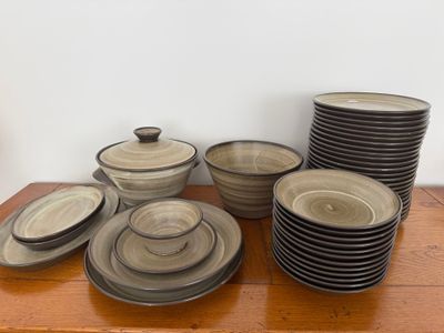 a lot of plates and bowls on a wooden table