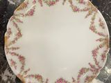 a close up of a white plate with pink flowers on it