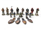 many figurines of different types of people on a white surface