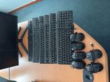 a lot of keyboards and mouses sitting on a desk
