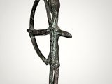 an image of a bronze statue of a man holding a bow
