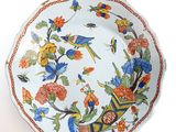 an image of a colorful plate with birds and flowers on it
