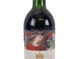 a close up of a bottle of wine on a white surface