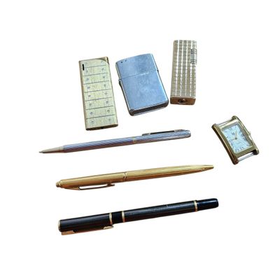 a lot of different pens and a cell phone on the table