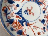 a blue and white plate with a red and blue design on it