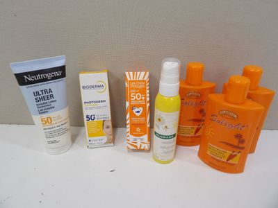 many sunscreens and sunscreens on a table