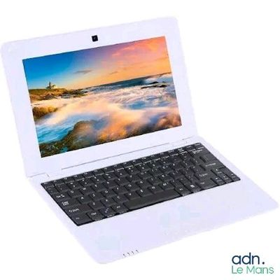 a white laptop with a picture of a beach on the screen
