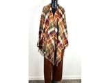 plaid blanket on mannequin stand in front of a white wall