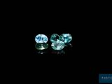 a pair of blue topazte gems on a black background