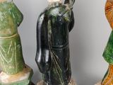 several figurines of different sizes and shapes are displayed on a white surface