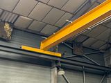 a crane that is hanging from the ceiling of a building