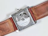 a watch that is sitting on a brown leather strap