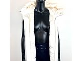 the mannequin is wearing a white jacket and black pants