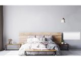 a bed with a wooden headboard and a night stand