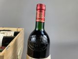 a bottle of wine that is sitting next to a box of wine
