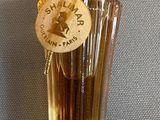 a bottle of perfume with a tag on it